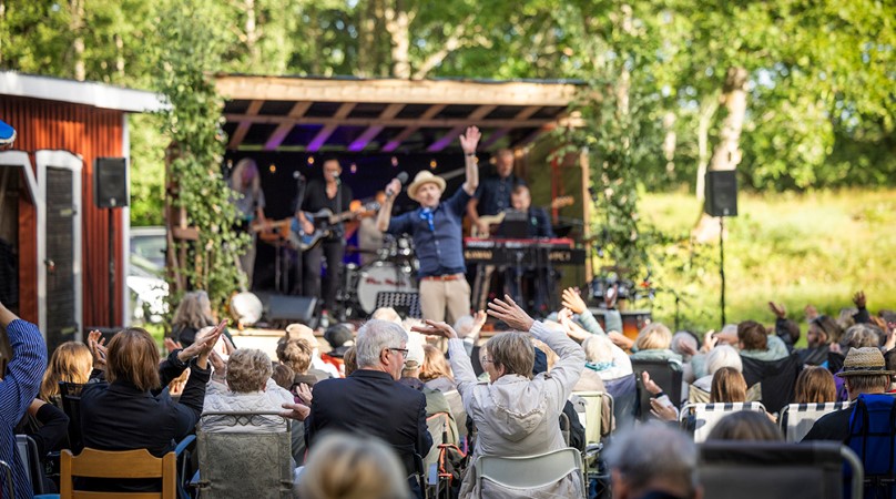 Musiker på scen framför sittande publik